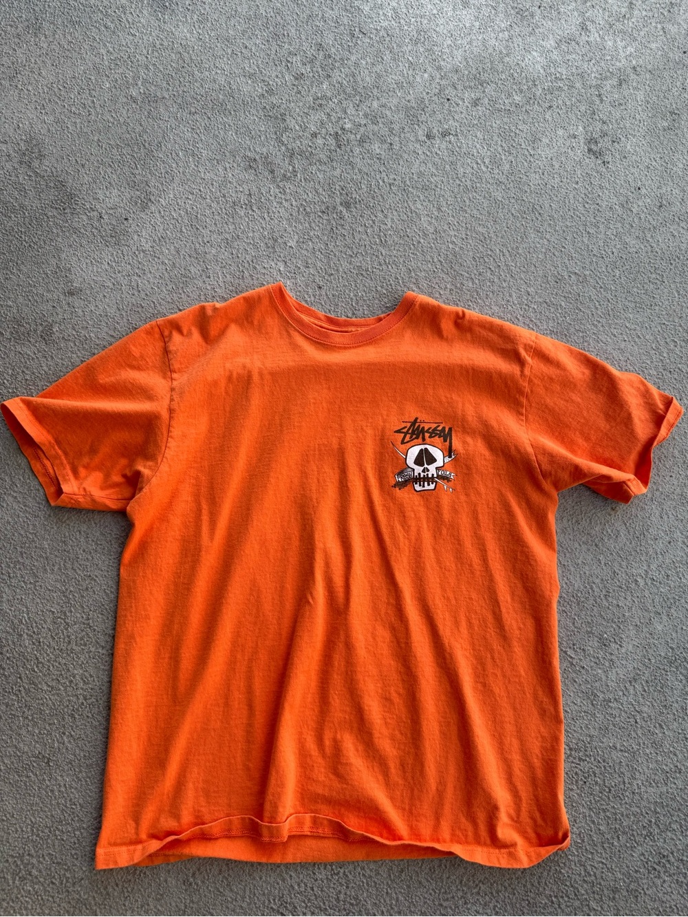 Stussy Orange Short Sleeve Tee with Skull Graphic